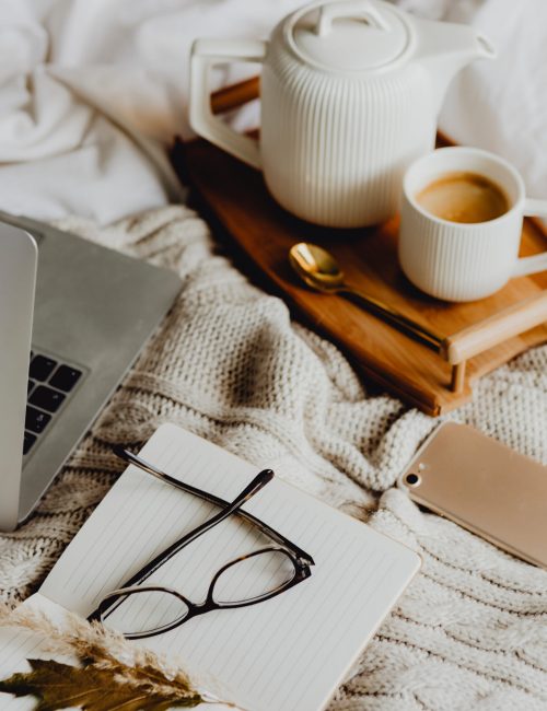 Working in bed with a laptop and coffee